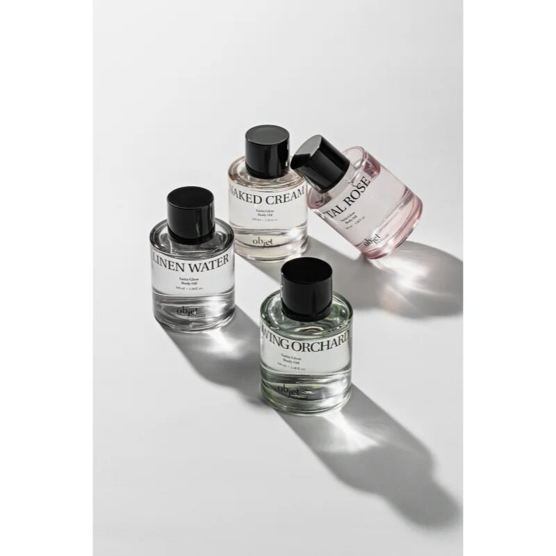 KUNDAL Objet Satin Glow Body Oil pečující tělový olej pro intenzivní hydrataci s vůní Glowing Orchard 100 ml