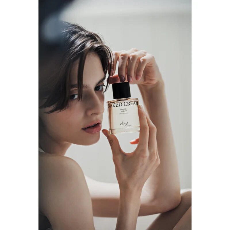 KUNDAL Objet Satin Glow Body Oil pečující tělový olej pro intenzivní hydrataci s vůní Naked Cream 100 ml